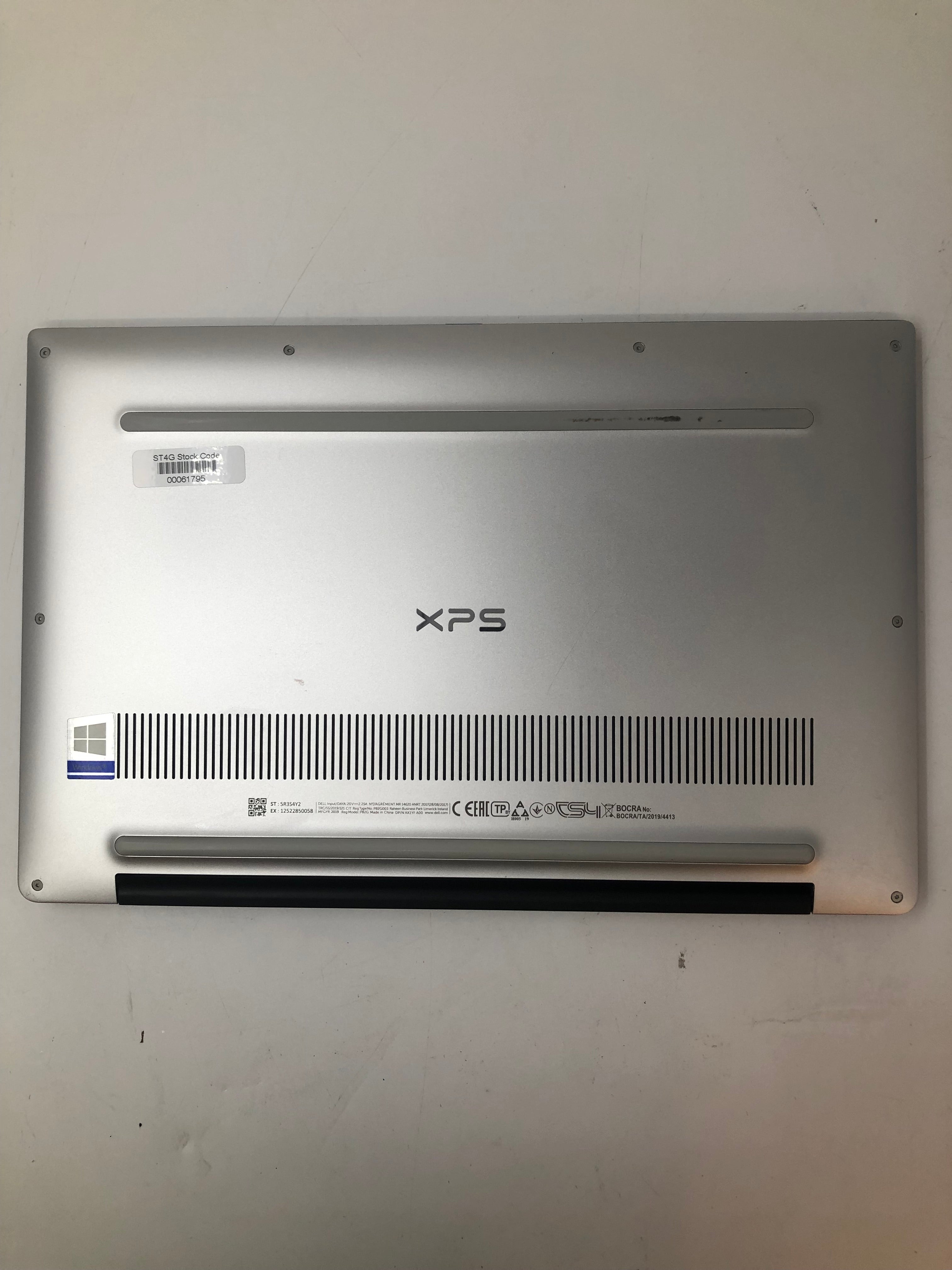 Dell XPS 13 7390 bottom view showing serial tags and vents