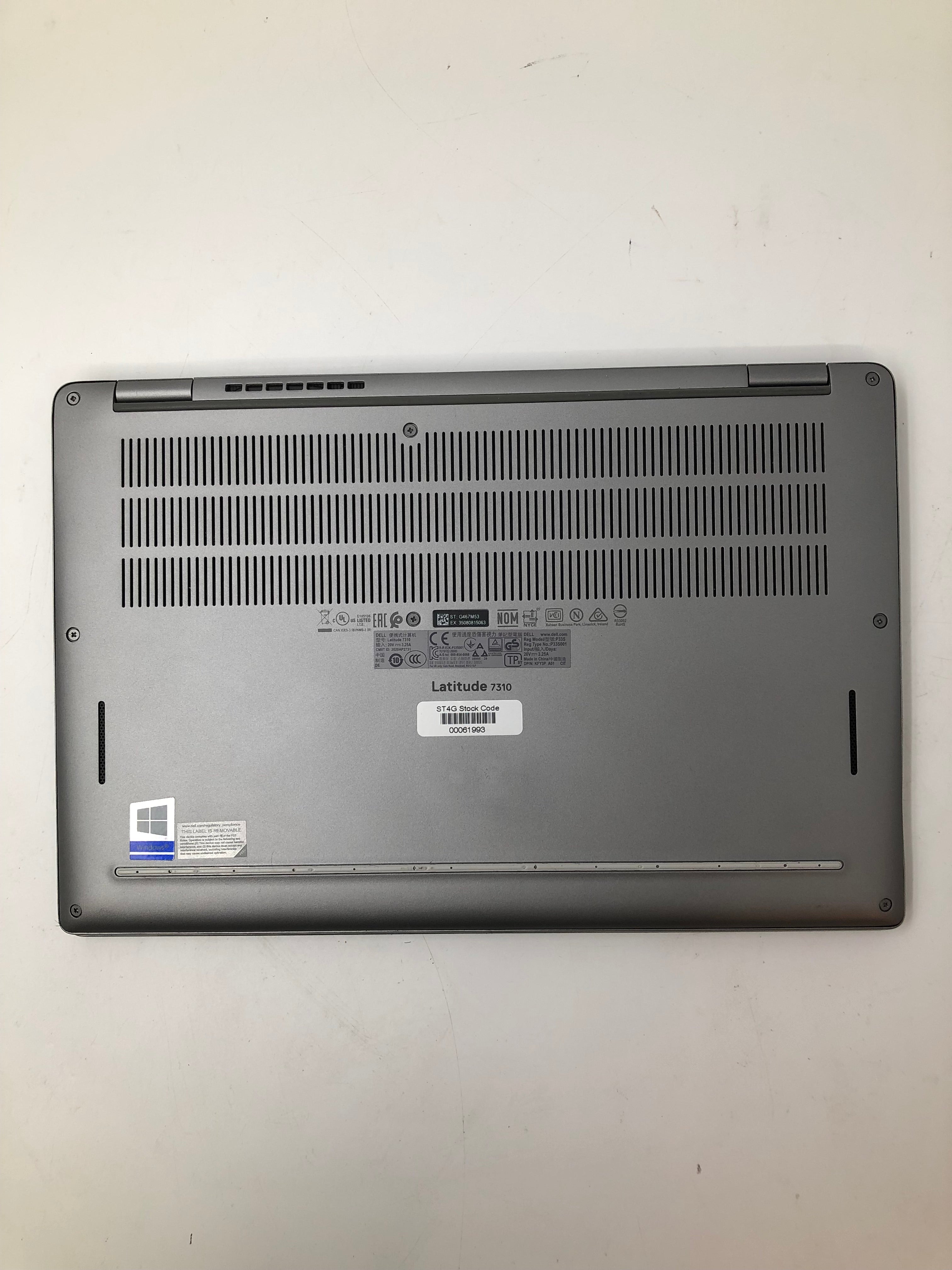 Dell Latitude 7310 bottom view showing serial tags and vents