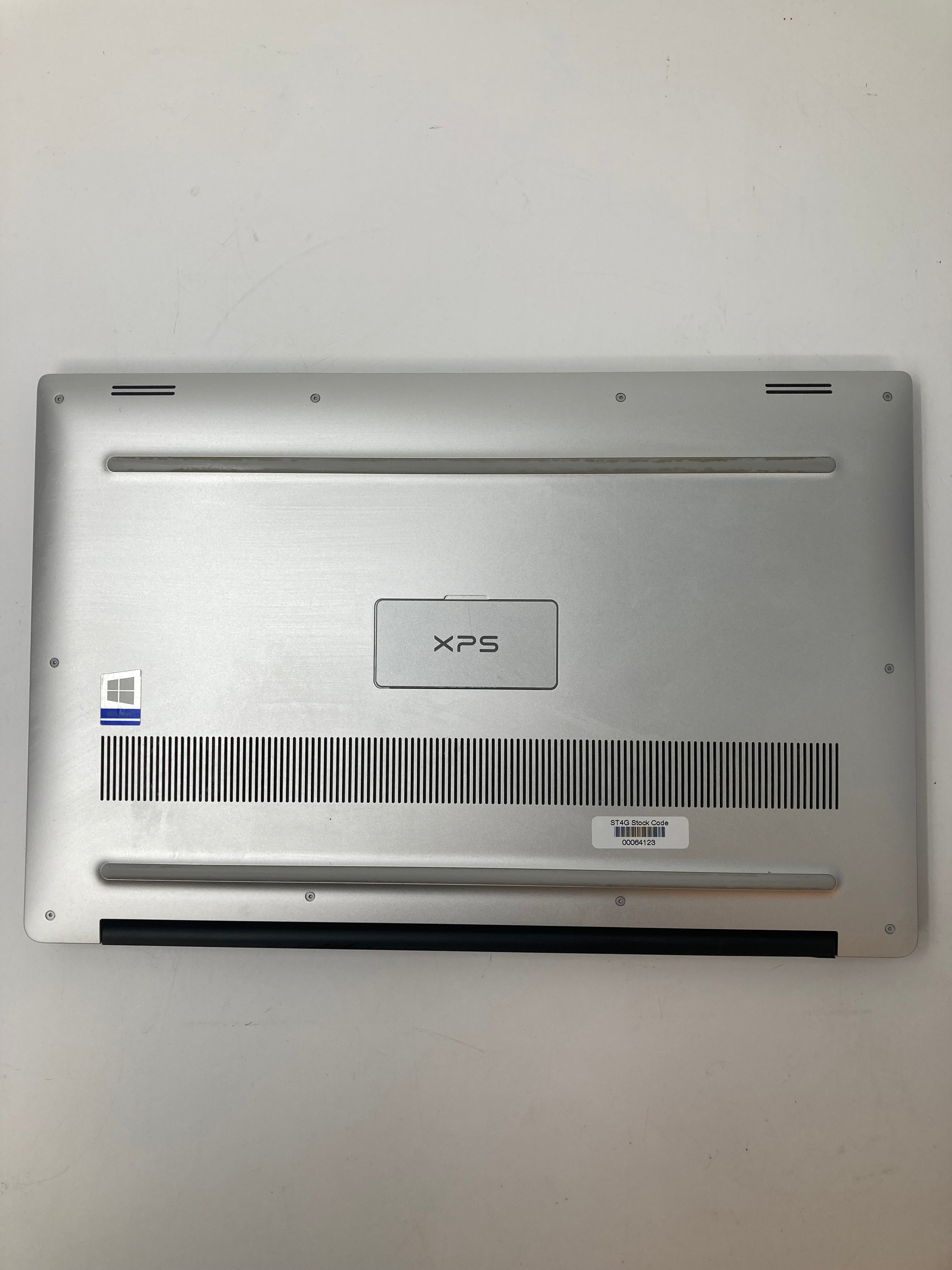 Dell XPS 15 7590 bottom view showing serial tags and vents