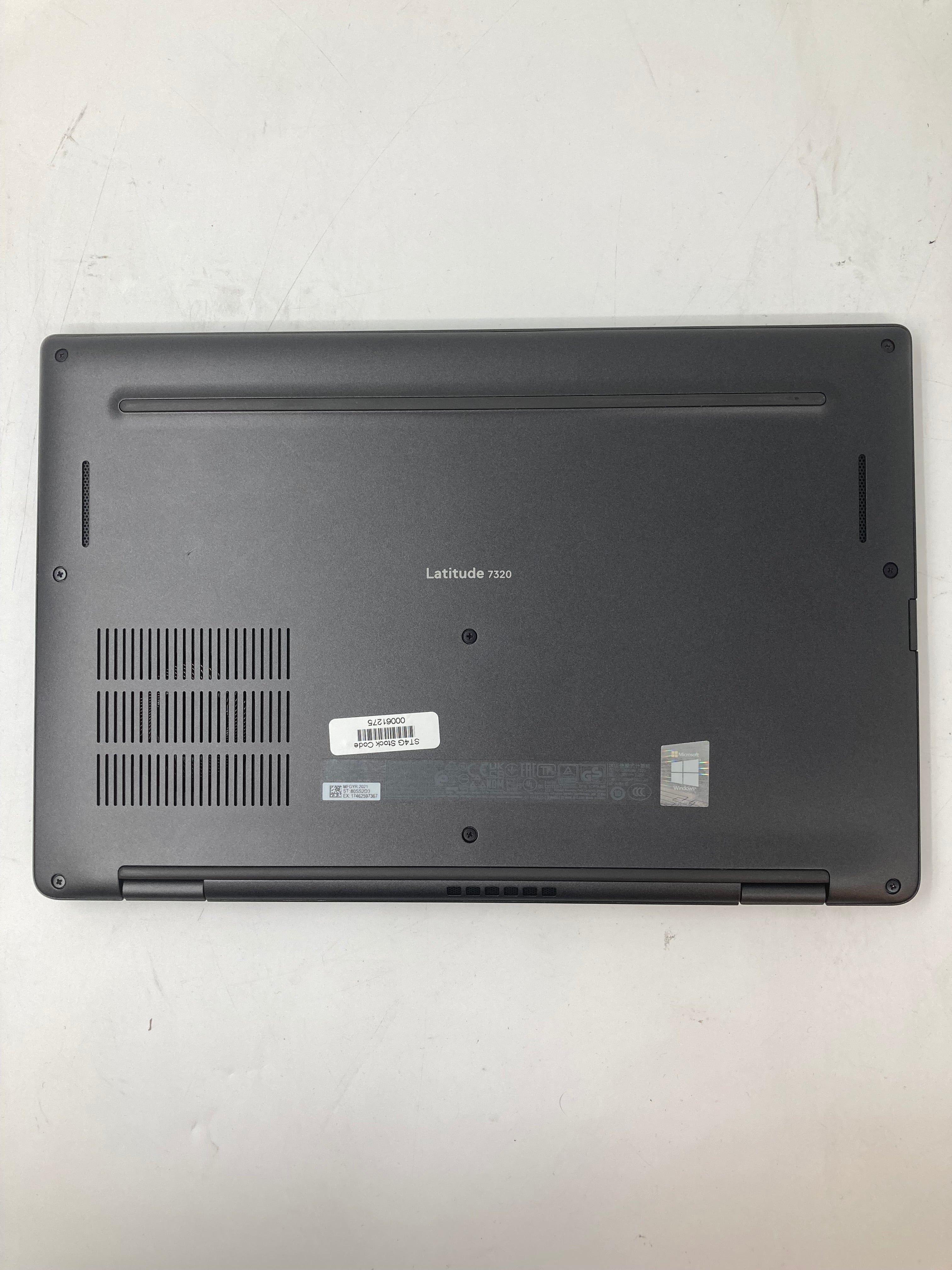 Dell Latitude 7320 bottom view showing serial tags and vents