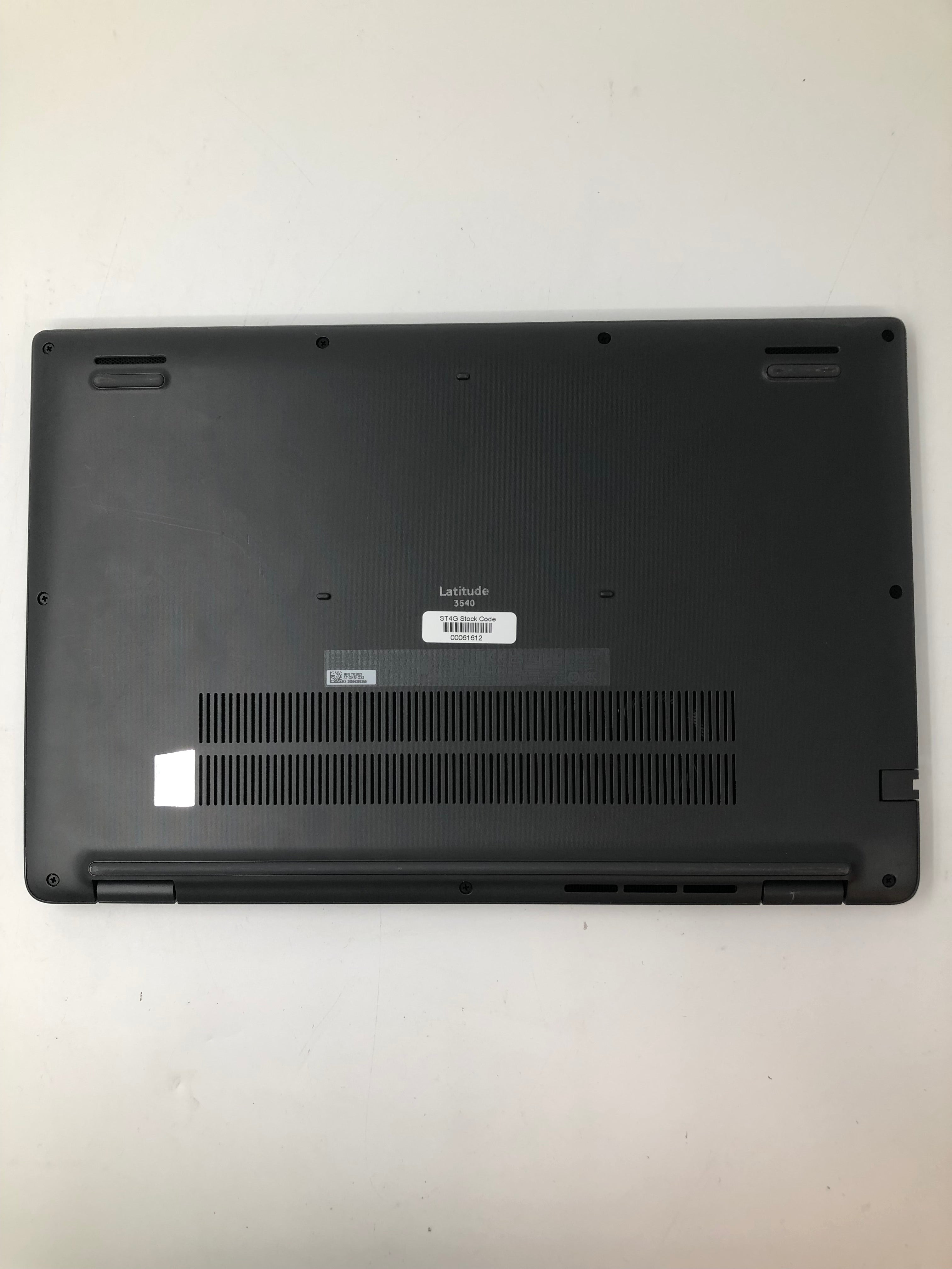 Dell Latitude 3540 bottom view showing serial tags and vents