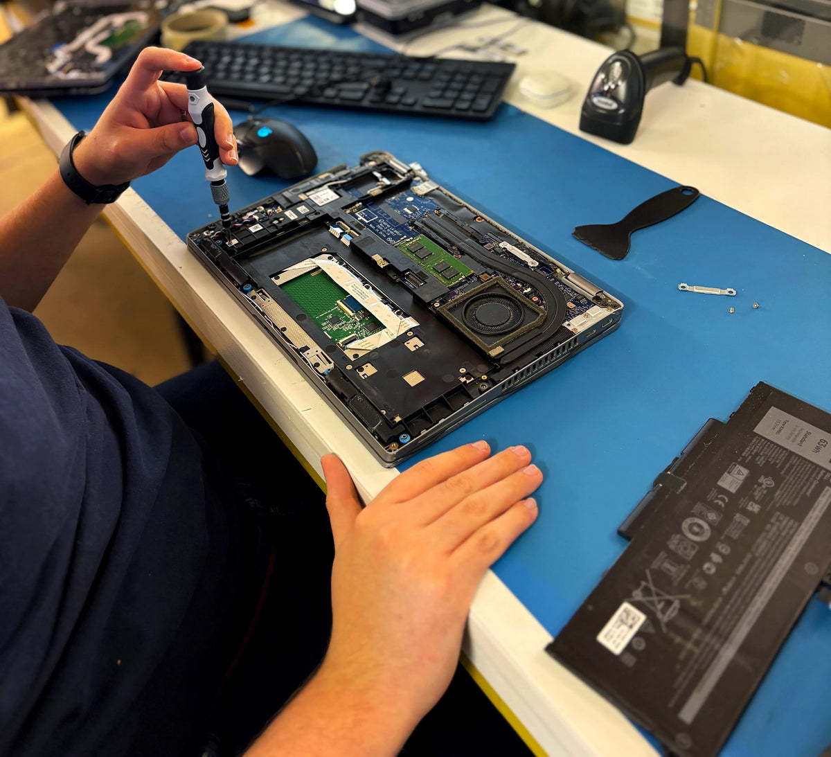Technician preparing refurbished devices